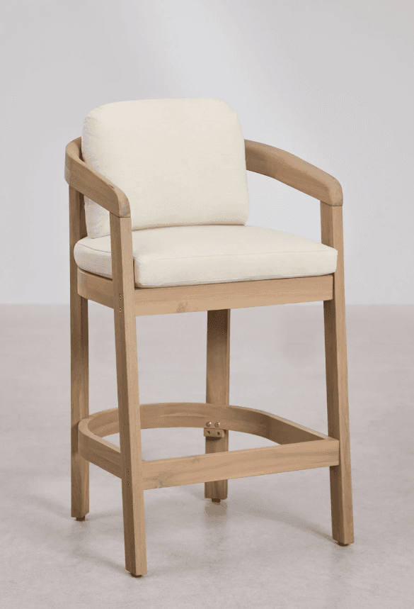 A tall wooden chair, functioning as a bar stool, featuring a light-colored natural wood frame with integrated armrests. It includes a square seat cushion and a rectangular back cushion, both upholstered in a plain, off-white fabric. The stool has a circular footrest near the base for comfort and stability. — 3D model