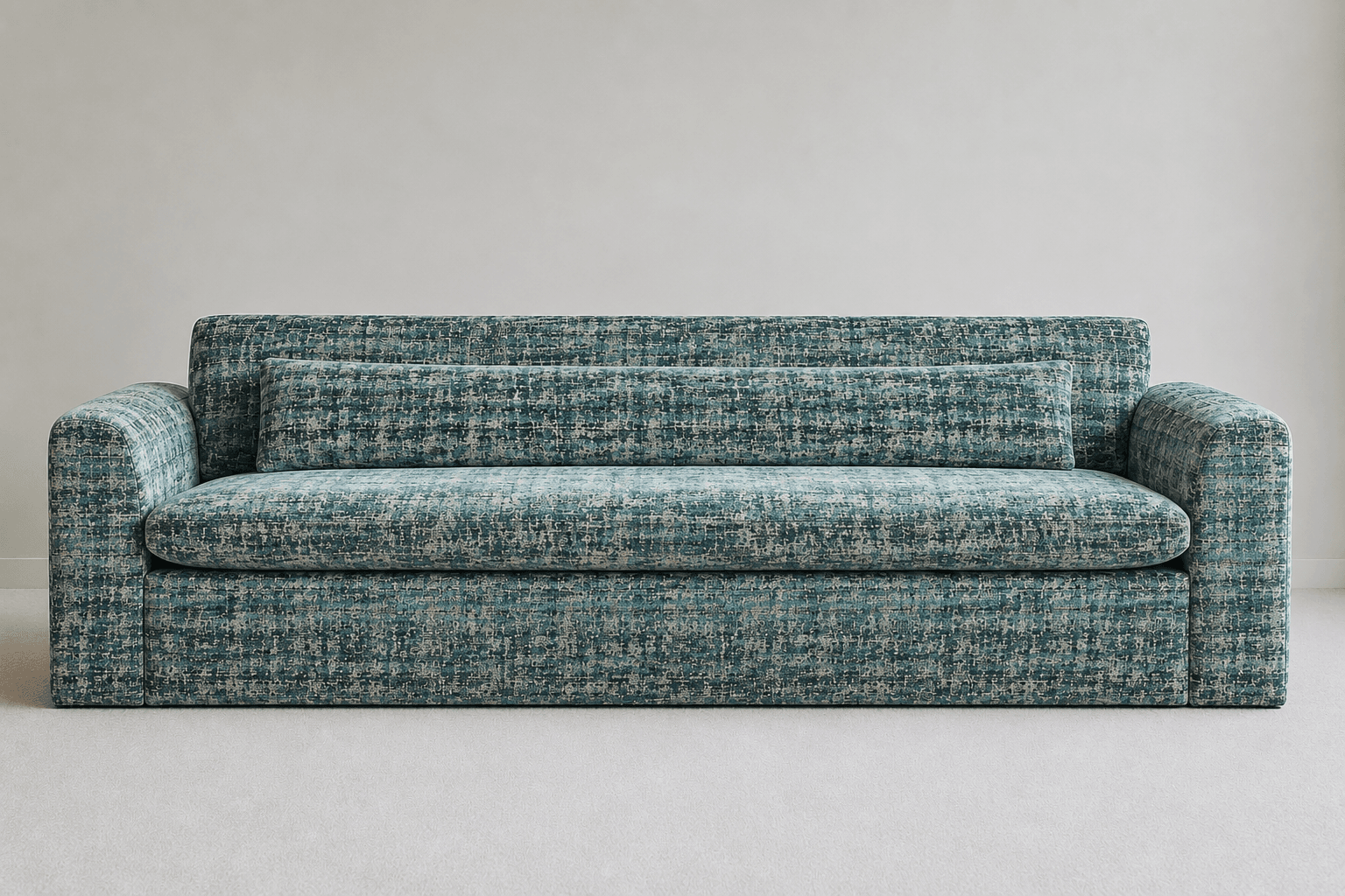 A contemporary sofa featuring a clean-lined, blocky silhouette and upholstered in a multi-tonal, heavily textured fabric primarily in shades of teal, blue-green, and grey. It has broad, rounded arms, a deep single seat cushion, and a single bolster-style back cushion. The base is also fully upholstered, creating a solid, grounded appearance. — 3D model