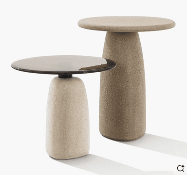 A minimalist pedestal side table featuring a circular top and a tapered cylindrical base, all rendered in a light beige, granular textured material. — 3D model