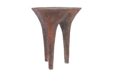 A small, three-legged end table with a textured, organic form. The tabletop is roughly circular and tapers downwards into three bulbous legs that spread outwards. The surface texture appears rough and pitted, suggesting a material like concrete, plaster, or a textured resin. — 3D model