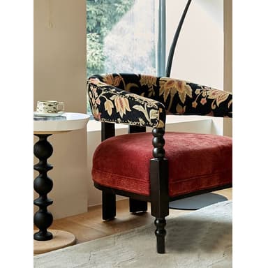 An upholstered barrel armchair featuring a continuous rounded back and armrests with floral pattern upholstery, a contrasting red velvet seat cushion, and dark turned wooden legs. — 3D model