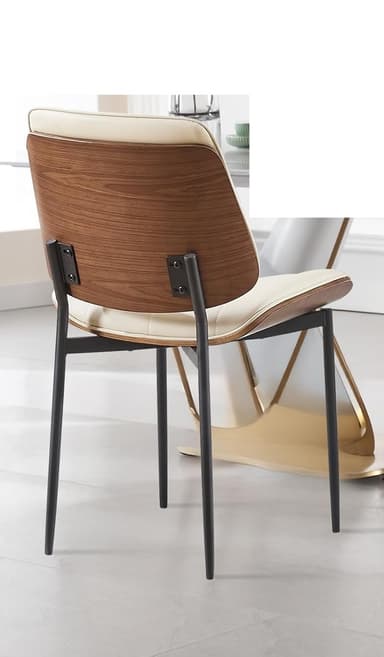 A dining chair with a curved, padded seat and backrest. The seat and backrest appear to be upholstered in a light-colored faux leather with decorative stitching. The chair has a thin wooden trim around the seat and backrest, and black metal legs. Dimensions are indicated for the backrest height (15.15 inches) and seat width (19.69 inches). — 3D model