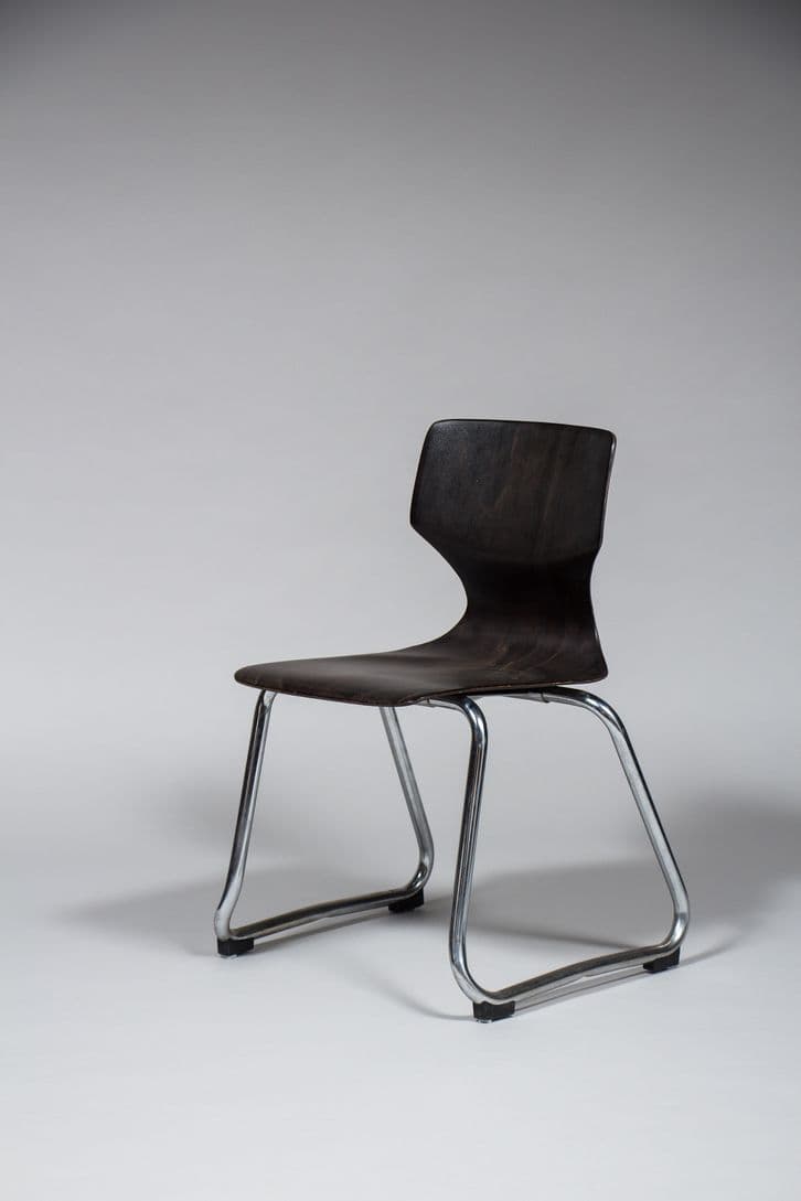 A modern chair with a molded seat and backrest, supported by a chrome-plated tubular steel frame. The seat and back are a single, continuous piece with a subtle ergonomic curve. The frame has a cantilevered design, offering a degree of flexibility. The chair is finished with black protective caps on the feet. — 3D model