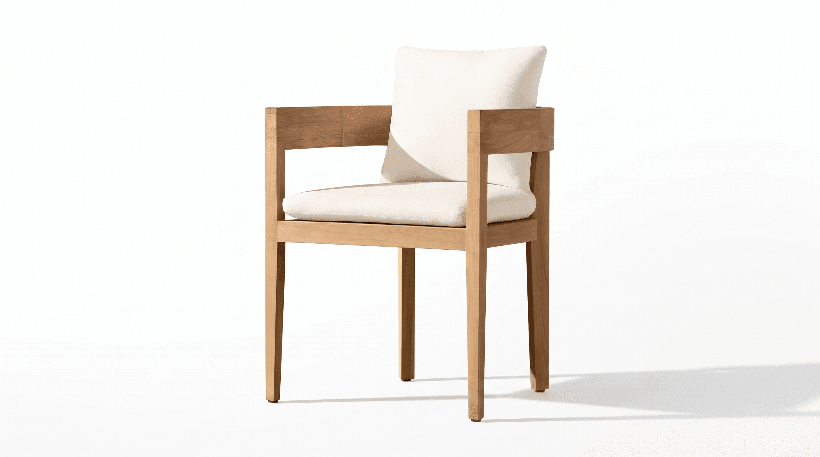 A modern armchair featuring a rectilinear wooden frame constructed from a light-toned hardwood, possibly teak. The chair includes a thick seat cushion and a back cushion, both upholstered in an off-white or cream-colored fabric. The frame has prominent, flat armrests and straight legs, emphasizing a clean, minimalist aesthetic. — 3D model