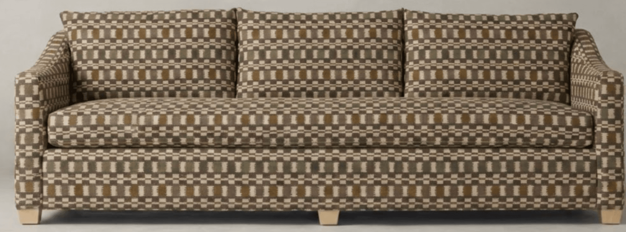 A three-seater sofa upholstered in a patterned fabric. The sofa has a straight back with three loose cushions, and padded arms that curve slightly outwards. It sits on four low, rectangular wooden legs. — 3D model