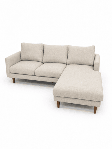 A contemporary sectional sofa upholstered in a light, textured beige fabric, featuring an integrated right-facing chaise lounge. The sofa has a clean-lined design with straight track arms, loose back cushions, and tapered wooden legs. — 3D model