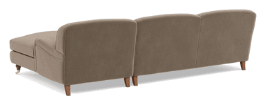 A modern sectional sofa with a chaise extension, upholstered in a light taupe fabric and featuring wooden legs, one with a brass caster. — 3D model