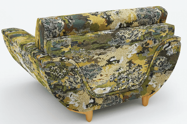 A single armchair upholstered in a textured fabric with a dense, abstract pattern featuring shades of green, brown, and white. The armchair has a rounded back and arms, with a prominent seat cushion. It is supported by four slender, tapered wooden legs. — 3D model