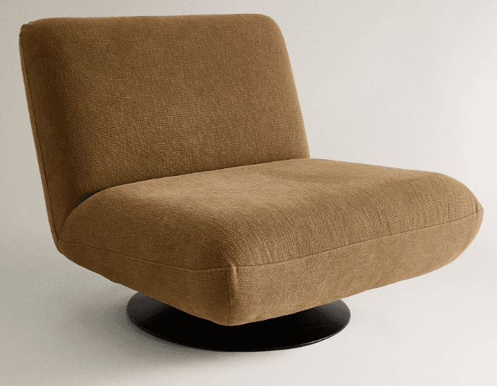 A contemporary armless lounge chair, fully upholstered in a textured brown fabric, resting on a flat, round black metal swivel base. The backrest is low and slightly reclined, seamlessly transitioning into the seat cushion. — 3D model