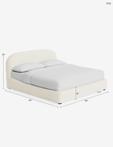 A contemporary platform bed featuring a fully upholstered frame and a gently curved or rounded headboard. The bed is covered in a light-colored, textured fabric, likely a boucle or similar weave, giving it a soft, inviting appearance. The design is minimalist, with the mattress sitting directly on the low-profile frame, and subtle, recessed feet. It is presented against a plain white background. — 3D model