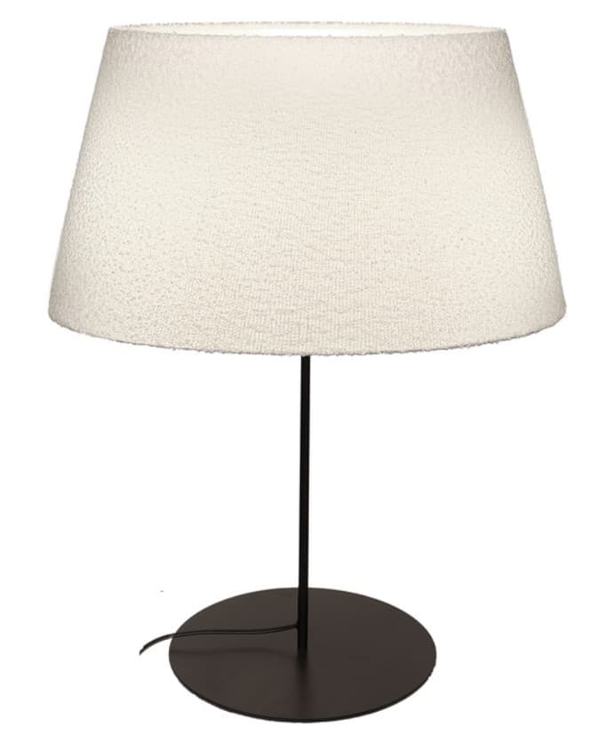 A contemporary table lamp featuring a minimalist design. It has a matte dark-colored circular base, a slender, straight stem, and is topped with a large, off-white conical lampshade. The shade exhibits a subtle, textured surface, possibly fabric, and is illuminated, indicating the lamp is operational. A power cord is visible emerging from the base. — 3D model