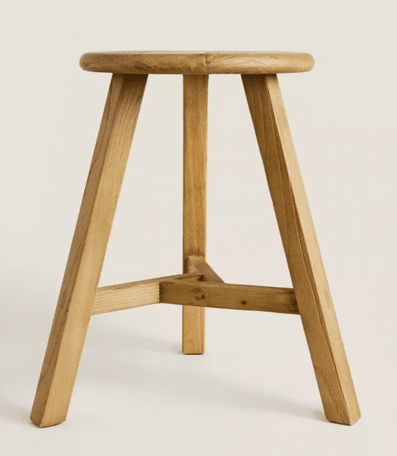 A three-legged wooden stool with a round seat and splayed legs. The legs are joined by a triangular stretcher system near the bottom. — 3D model