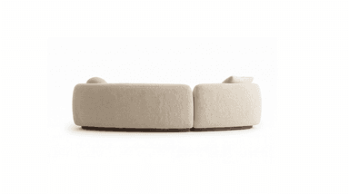 A two-piece modular sectional sofa upholstered in cream boucle fabric, featuring soft, rounded forms and resting on a dark wooden plinth base. One section includes a loose back cushion, and the other has a cylindrical bolster cushion. — 3D model