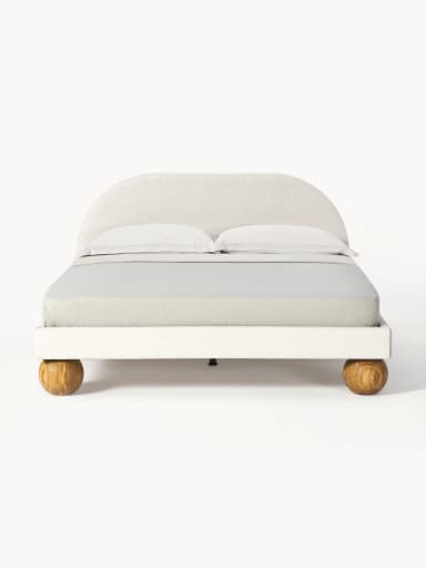An upholstered bed frame featuring a gently arched headboard and distinctive spherical wooden feet, presented with neutral bedding. — 3D model