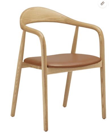 A Scandinavian modern armchair constructed from light-colored ash wood with a subtly visible grain. It features a continuous, gently curved element that forms both the backrest and the armrests, creating a fluid silhouette. The seat is a flat, padded cushion upholstered in a cognac-colored leather or faux leather. The frame is supported by four round, slightly tapered legs, connected by simple stretchers beneath the seat. — 3D model