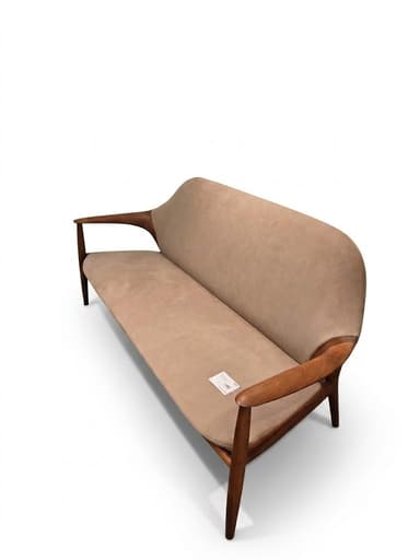 A two-seater sofa or loveseat featuring a visible wooden frame and light beige upholstery. The frame has a distinct, curved design, forming both the armrests and the legs. The backrest is gently curved, offering a streamlined aesthetic. — 3D model