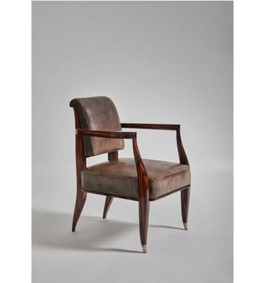A sophisticated armchair featuring an exposed dark brown wood frame and rich grey-brown leather upholstery. The chair has subtly curved armrests and tapered legs, with polished metallic caps on the feet, adding a touch of elegance. The seat and backrest are well-padded, providing comfort, while the visible wood grain enhances its natural appeal. The design blends classic elements with a transitional aesthetic, suitable for various interior styles. — 3D model