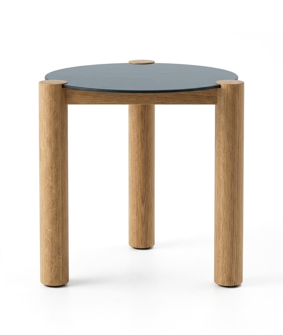 A minimalist round accent table featuring three cylindrical oak wood legs and a contrasting dark gray, matte round tabletop. A small natural wood plug or dowel is visible in the center of the tabletop. — 3D model