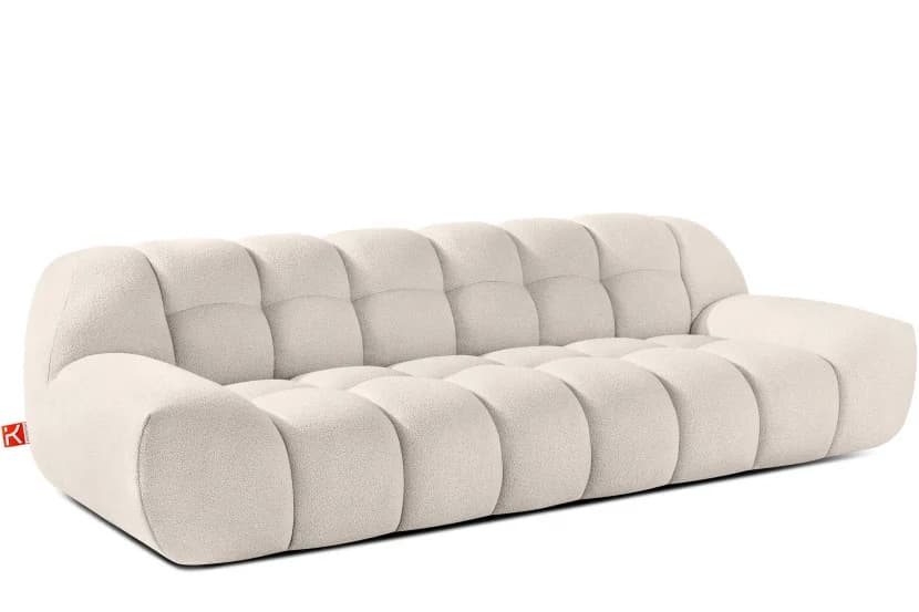 A tufted, off-white sofa with a low profile and rounded armrests. The sofa features a distinctive channel-tufted design across the seat and back cushions, creating a series of plush, pillowy segments. The overall form is organic and contemporary. — 3D model