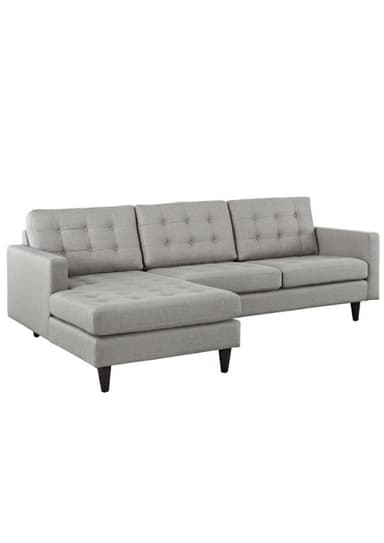 A light gray upholstered sectional sofa featuring a left-hand facing chaise lounge, button-tufted back cushions, and dark tapered wooden legs. — 3D model
