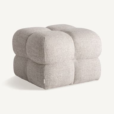 A low, upholstered ottoman with rounded edges, divided into four cushioned sections by stitched seams. The upholstery has a textured appearance with a mix of light and dark fibers, giving it a speckled effect. A small white tag with 'VICAI' is visible on the lower left side. — 3D model