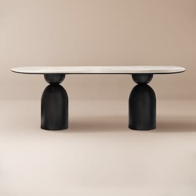 A contemporary coffee table featuring a elongated oval tabletop with a white marble-look surface, supported by two robust, rounded, black drum-shaped bases. The design is minimalist and sculptural. — 3D model