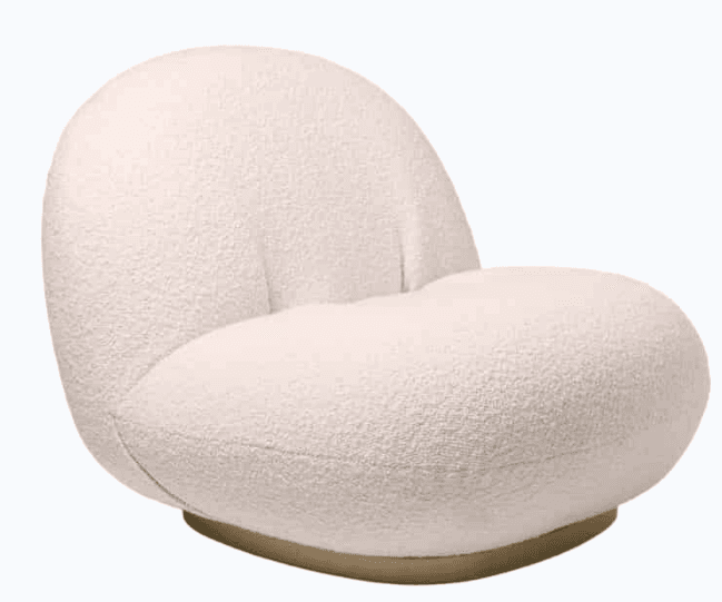 A contemporary armchair with a rounded, organic silhouette. The chair features a low profile, a deeply cushioned seat and backrest, and is upholstered in a textured, boucle-like fabric. It is supported by a subtle, circular base. — 3D model