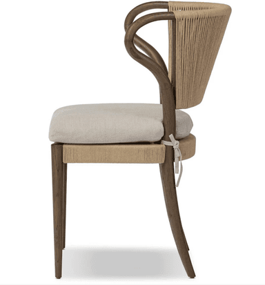 A dining chair with a wooden frame. The backrest is constructed from tightly woven rope or cord in a vertical pattern, extending from the seat base to the curved top of the backrest. The seat is cushioned and upholstered in a textured fabric. The chair has four wooden legs, with the front legs being straight and the back legs tapering slightly. The armrests are integrated into the wooden frame and curve upwards. — 3D model