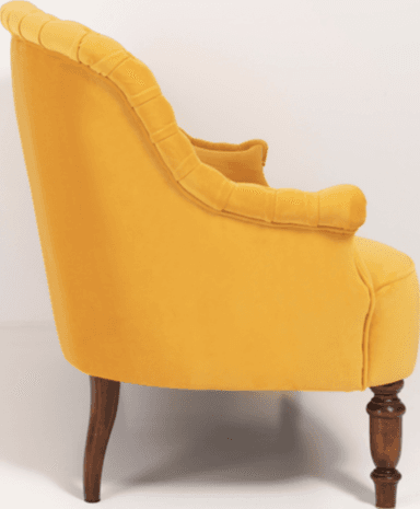 A traditional style armchair upholstered in a rich yellow velvet fabric. The chair features distinct rolled arms and a rolled crest rail on the backrest. It has four wooden legs, with a visibly turned leg at the front and a tapered leg at the rear. — 3D model