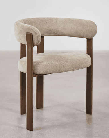 A contemporary accent chair with a curved backrest and seat, upholstered in a textured, light-colored fabric. The chair features a distinctive frame constructed from dark wood, with four legs providing support. The arms are integrated into the backrest structure. — 3D model