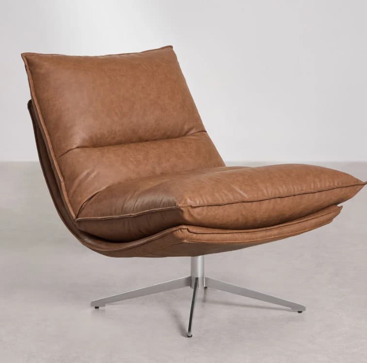 A modern armchair with a low-profile design and a swivel base. The chair features a deep seat and a generously padded backrest, both upholstered in brown leather. The seat appears to be suspended or cantilevered from a curved frame that transitions into a brushed metal, four-pronged pedestal base with individual feet. — 3D model