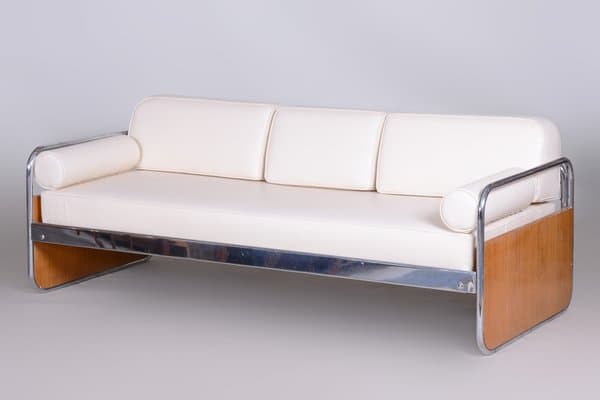 A three-seater sofa characterized by its tubular chrome frame, light wood end panels, and white upholstered cushions. The sofa features a minimalist design with a visible metal frame that extends to form the legs and back support. It includes three separate seat cushions, three back cushions, and two cylindrical bolster armrests at each end. The wood panels are integrated into the frame at the side ends. — 3D model