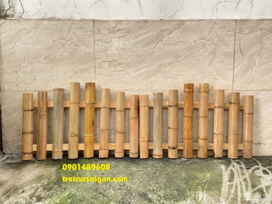 A decorative panel constructed from numerous vertical bamboo poles of varying heights, secured together by horizontal wooden slats. The poles exhibit natural color variations and are hollow at the top, arranged in an ascending pattern. — 3D model