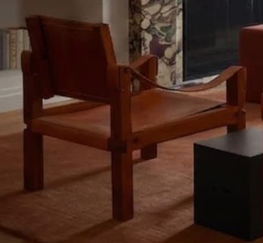 A modern lounge chair featuring a sturdy wooden frame and suspended brown leather elements forming the seat, backrest, and armrests. The design emphasizes natural materials and clean lines, offering a relaxed seating posture. — 3D model