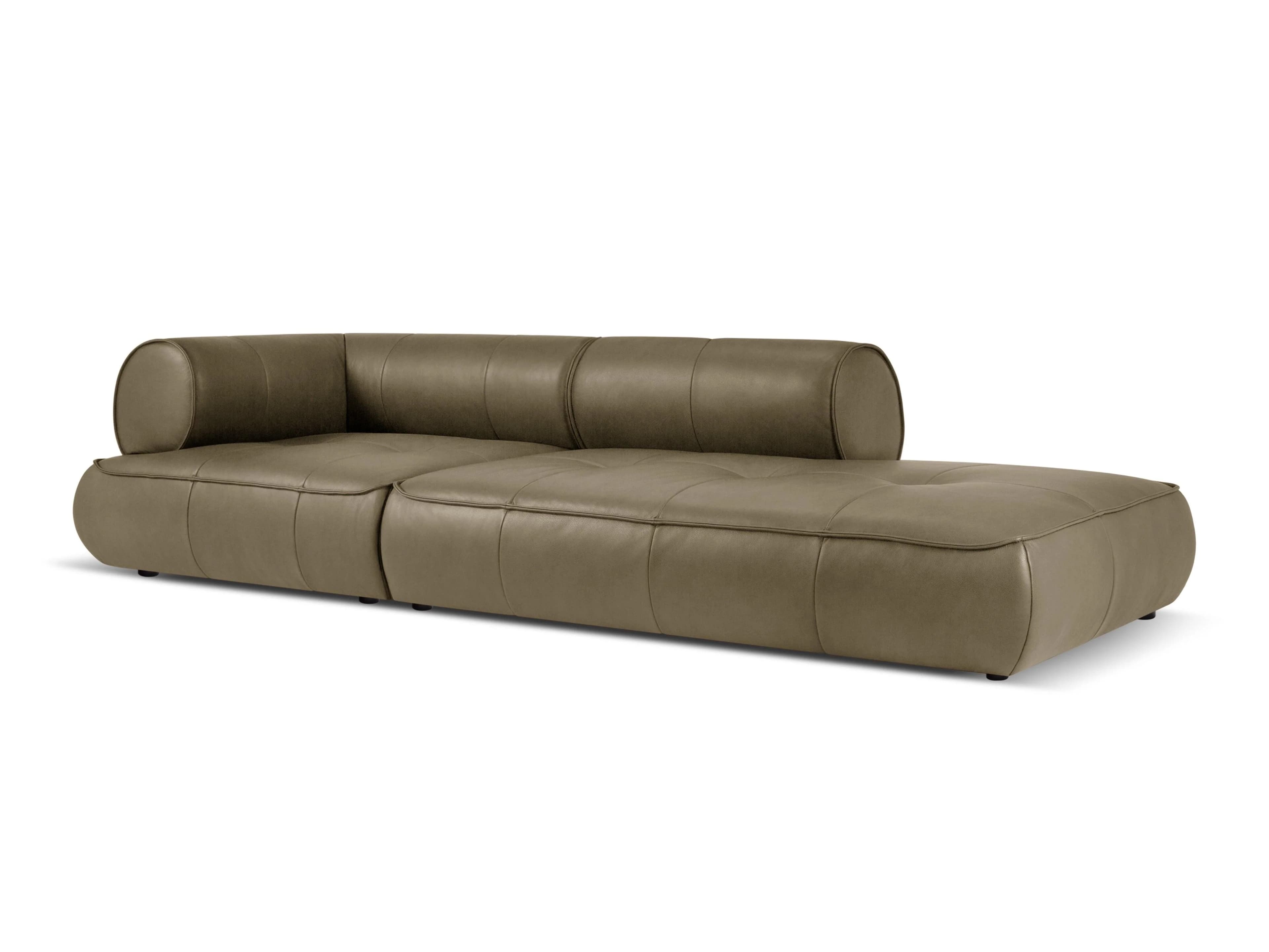 A modern, low-profile sectional sofa with a chaise lounge extension. The sofa features a rounded armrest on one side and a tufted seat with channel stitching. The upholstery appears to be a smooth, matte leather or a high-quality synthetic material. The overall design is minimalist and sleek. — 3D model
