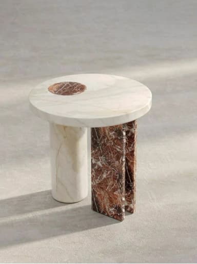 A round side table crafted from two distinct types of marble, featuring a cream-colored top with a recessed circular inlay of reddish-brown marble. The base is composed of an asymmetric arrangement: one cylindrical leg of the cream marble and two flat, rectangular panels of the reddish-brown marble, creating a visually striking and modern design. — 3D model