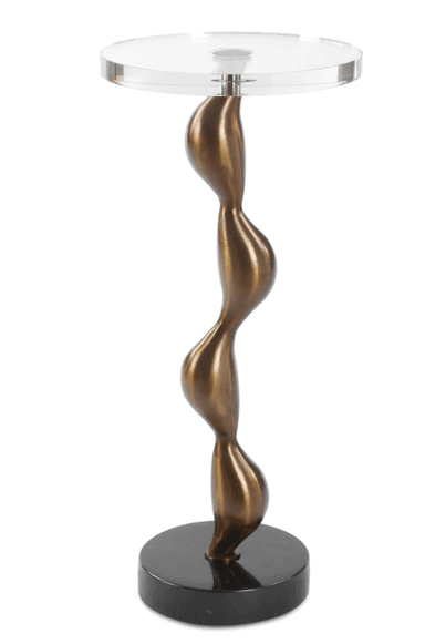 A tall, slender accent table featuring a clear round acrylic top, supported by a sculptural, wavy, bronze-finish metal pedestal, resting on a flat, round black base. — 3D model