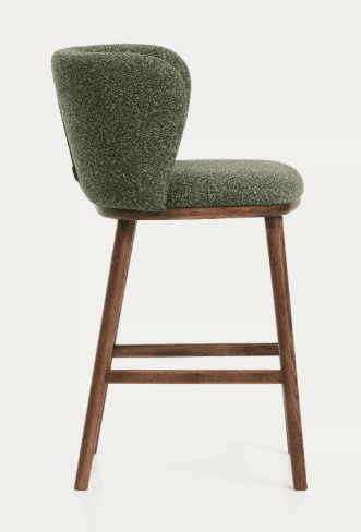 A bar stool with a curved, upholstered backrest and seat, supported by four wooden legs connected by a footrest. The stool features a textured, greenish-brown fabric for the seating and backrest, and a dark wood finish for the frame. — 3D model