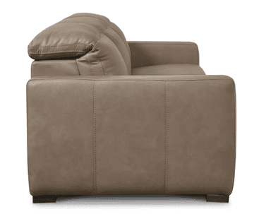 A three-seater sofa with a neutral taupe upholstery, featuring plush, overstuffed cushions on the back and seat. The arms are padded and squared, with visible stitching details along the edges and seams. The base of the sofa is solid and rests on short, dark rectangular feet. — 3D model