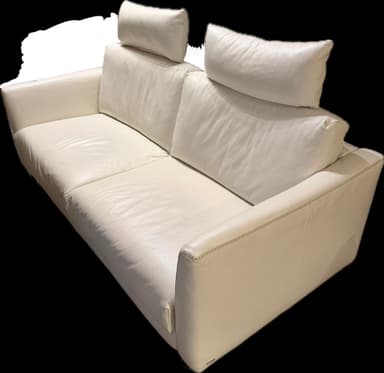 A modern sofa upholstered in white or off-white leather, featuring a minimalist design with a low profile. It has integrated, wide armrests and a deep seat. The backrest is formed by multiple loose cushions, which are secured by visible black straps. The upholstery exhibits subtle texture and detailed stitching along the edges, suggesting a contemporary and sophisticated aesthetic. — 3D model
