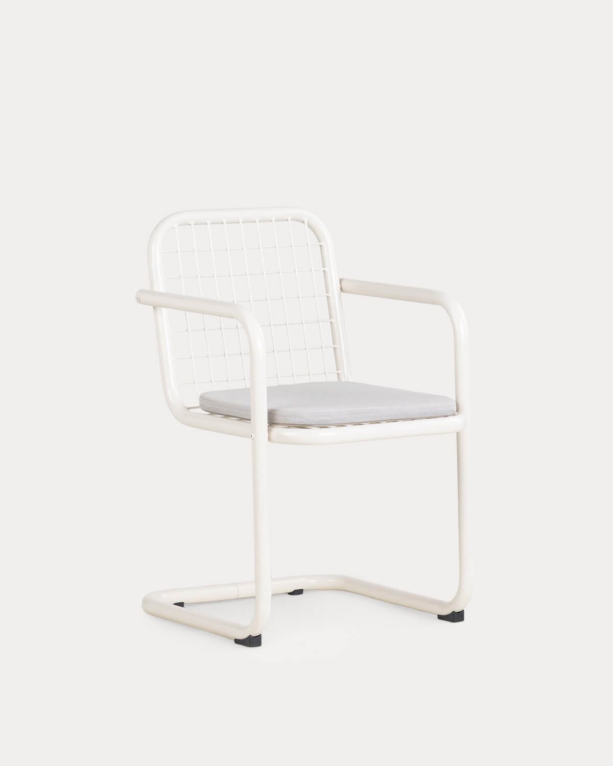 A modern armchair featuring a cream-colored tubular metal frame with a cantilever base, a grid-patterned backrest, and a light grey removable seat cushion. The design emphasizes clean lines and industrial materials. — 3D model