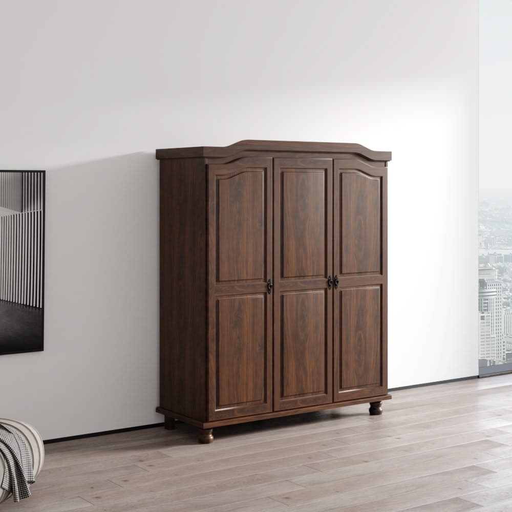 A traditional dark wood three-door wardrobe featuring classical design elements such as a scalloped top edge, carved door panels, and turned bun feet. The wardrobe is presented against a minimalist white wall in a bright room. — 3D model