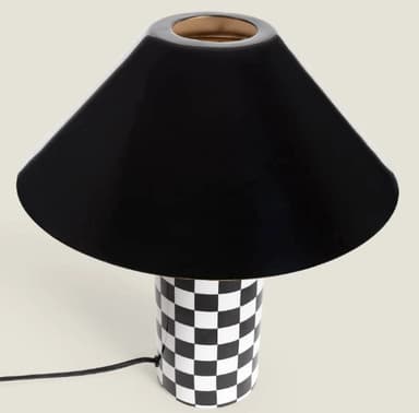 A contemporary table lamp featuring a cylindrical base adorned with a black and white checkerboard pattern, a brass-finished stem, and a glossy black conical shade. — 3D model