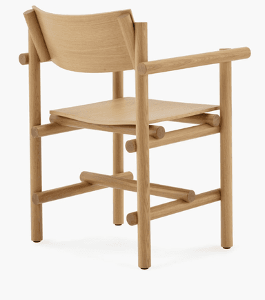 A wooden armchair with a minimalist and modern design. The chair features a curved backrest, a gently sloped seat, and armrests supported by cylindrical elements. The frame is constructed from solid wood with visible joinery, suggesting a focus on craftsmanship and natural materials. The legs are straight and supported by horizontal wooden pieces. — 3D model
