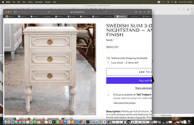A white painted wooden nightstand featuring three functional drawers, ornate brass-toned circular pull handles, and intricately carved details on its frame and drawer fronts. The piece stands on four fluted, turned legs, contributing to its elegant, traditional aesthetic. The top surface is flat and plain, complementing the decorative elements below. — 3D model