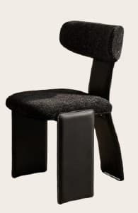 An avant-garde side chair featuring a distinctive sculptural form. It has a rounded, upholstered backrest and a flat, upholstered seat. The chair's legs consist of a broad, flat panel forming the back support and a substantial, upholstered block for the front support, creating a unique, cantilevered appearance. — 3D model