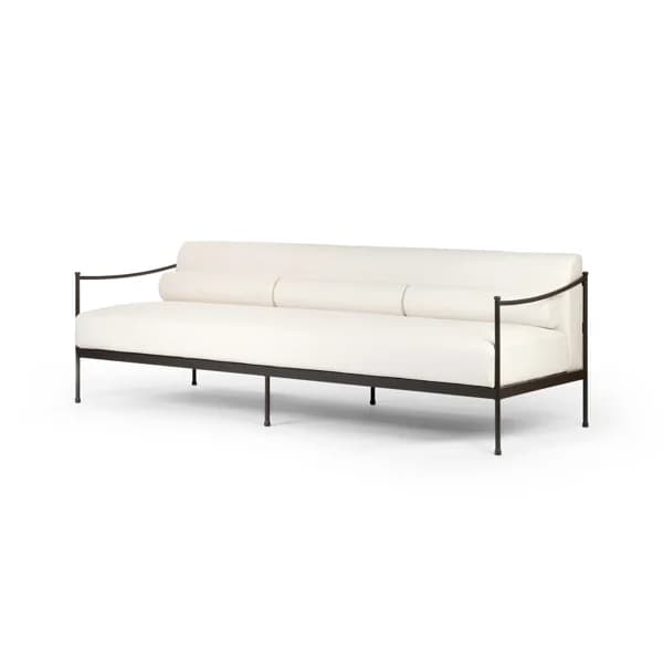 A long, upholstered seating unit featuring a minimalist dark metal frame that elegantly encompasses the seat and backrest. The sofa is upholstered in a light, off-white fabric and features a distinctive backrest composed of three integrated cylindrical bolster cushions. The armrests are thin, curved metal elements extending from the main frame, contributing to its open silhouette. The entire piece is supported by multiple slender metal legs. — 3D model