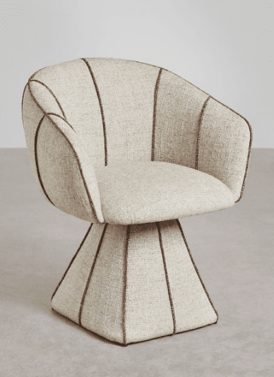 A modern armchair with a sculptural, pedestal base. The chair features a rounded seat and backrest, upholstered in a textured, light-colored fabric. Distinctive piping in a darker shade accentuates the seams of the upholstery, creating a segmented, fan-like pattern on the backrest and a geometric, truncated pyramid shape for the base. — 3D model