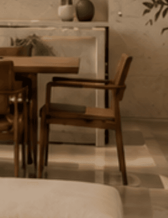 A wooden armchair with upholstered seat and backrest. The frame and armrests are constructed from wood with a visible grain. The upholstery is a textured fabric in a brown hue. The chair has four legs and a simple, modern design. — 3D model