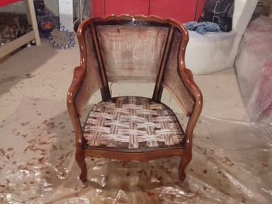 An armchair frame in a Rococo Revival or French Provincial style, featuring a reddish-brown polished wood finish. The frame exhibits curvilinear lines, carved details on the crest rail, and elegant cabriole legs. The back and armrests are upholstered in a light-colored fabric, while the seat's webbing is exposed, indicating it is an unfinished piece or frame for reupholstery. — 3D model